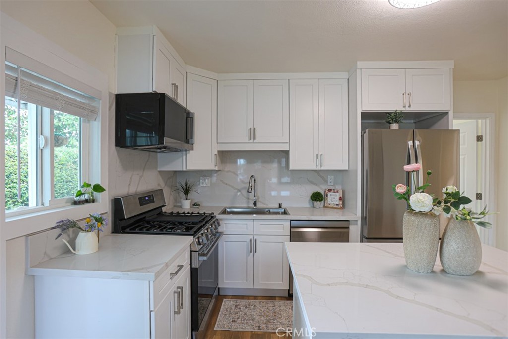 600 South Emily Street Anaheim, CA 92805 - Photo 5 of 22 a kitchen with stainless steel appliances granite countertop a refrigerator sink and stove