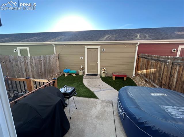 6382 Pilgrimage Road Colorado Springs, CO 80925 - Photo 27 of 32 Patio between 2 car garage and townhome with HotTub