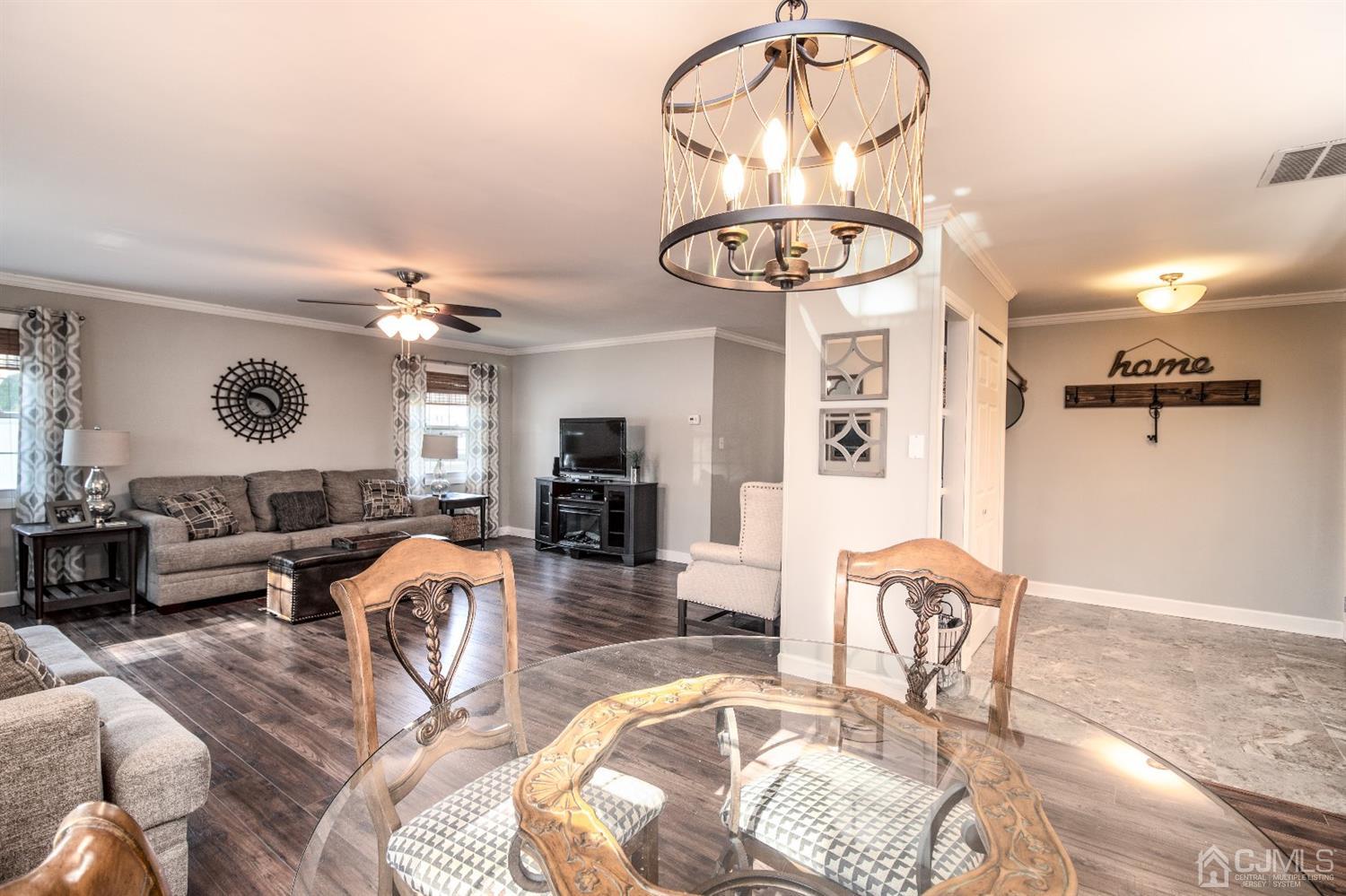 15 Johnson Road Somerset, NJ 08873 - Photo 5 of 26 a view of a livingroom and a dining room with furniture wooden floor and chandelier