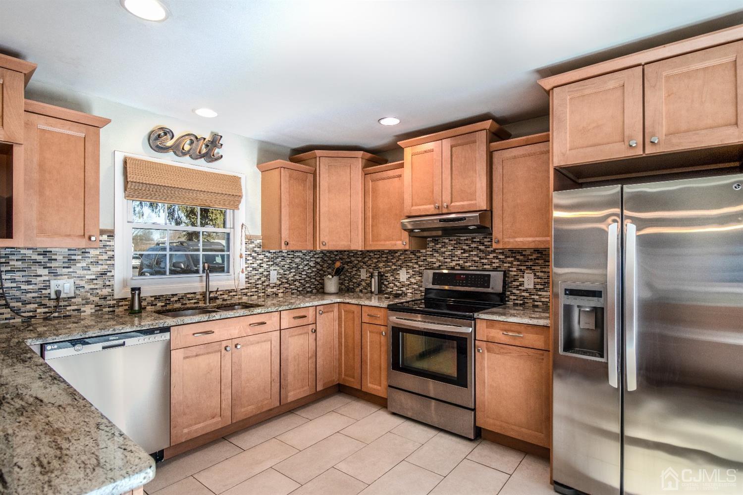 15 Johnson Road Somerset, NJ 08873 - Photo 8 of 26 a kitchen with stainless steel appliances granite countertop a sink stove and refrigerator