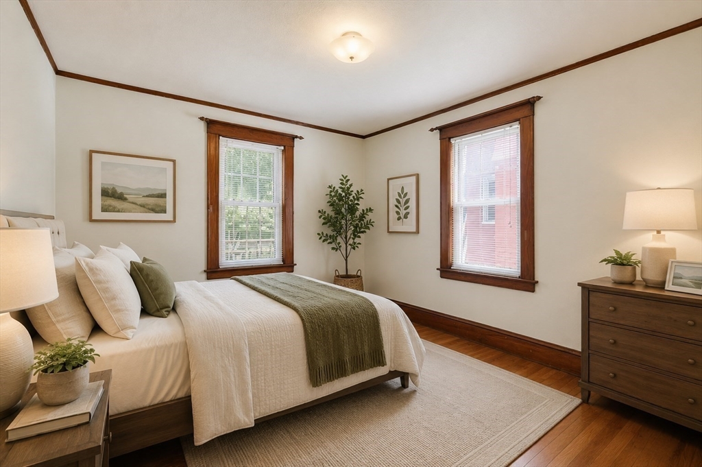 157 Elm Street Somerville, MA 02144 - Photo 10 of 19 a bedroom with a bed dresser and window