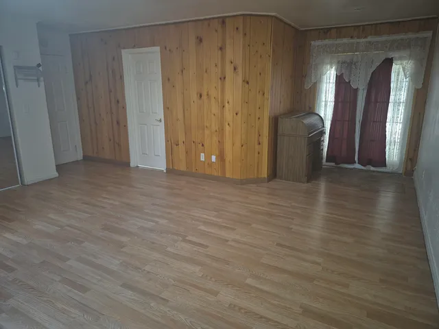 a view of a room with wooden floor