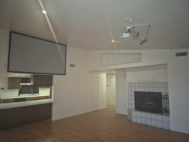 a room with a fireplace and wooden floor