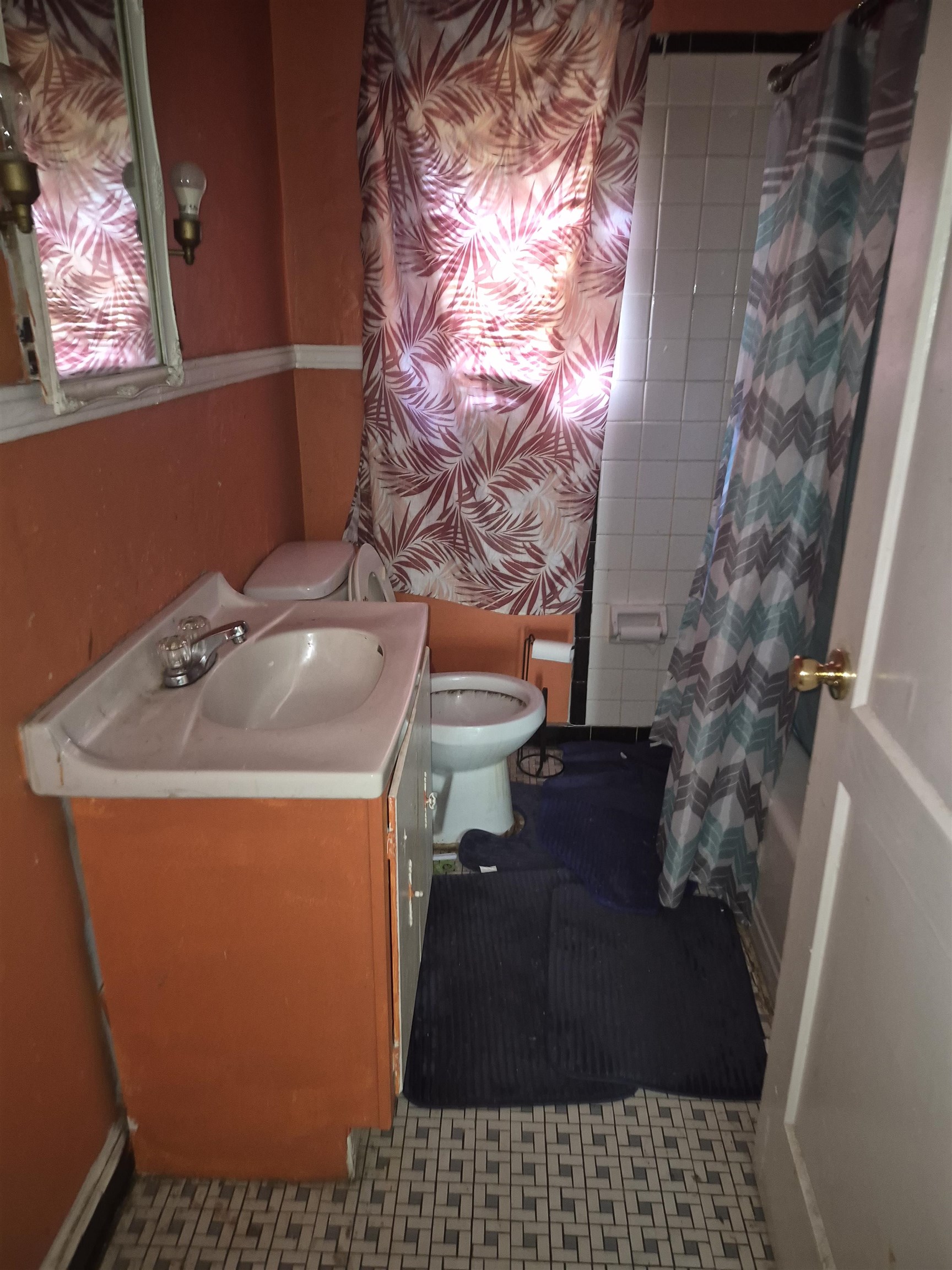 Bathroom featuring vanity and shower / bathtub combination with curtain