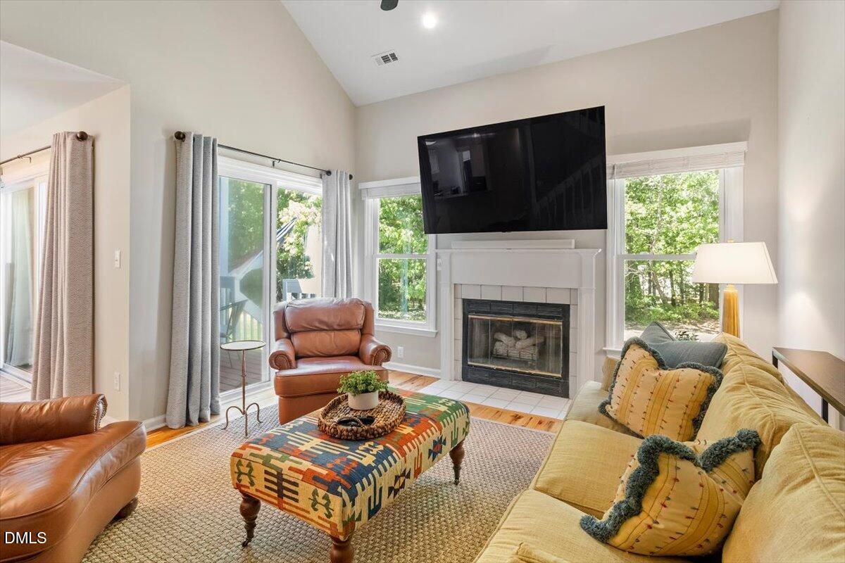 8321 Hempshire Place, Unit 103 Raleigh, NC 27613 - Photo 5 of 25 a living room with furniture fireplace and flat screen tv