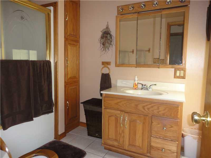 148 Swamp Run Road Butler, PA 16001 - Photo 12 of 23 Full Bath. Family bathroom has oak cabinets and a ceramic tile floor along with lots of linen storage.