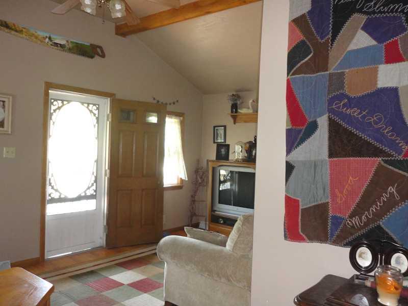 148 Swamp Run Road Butler, PA 16001 - Photo 3 of 23 Family Room. The living room is light & bright with vaulted & beamed ceiling. The front door opens to a covered porch where you can watch the cattle & horses play & graze. Oak trim accents the painted walls.