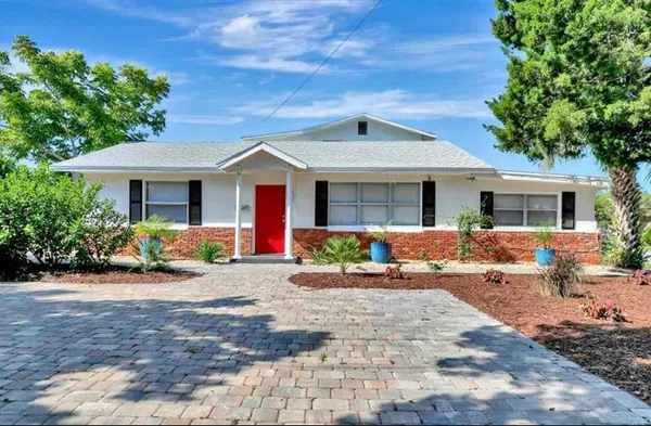 a front view of a house with yard and porch