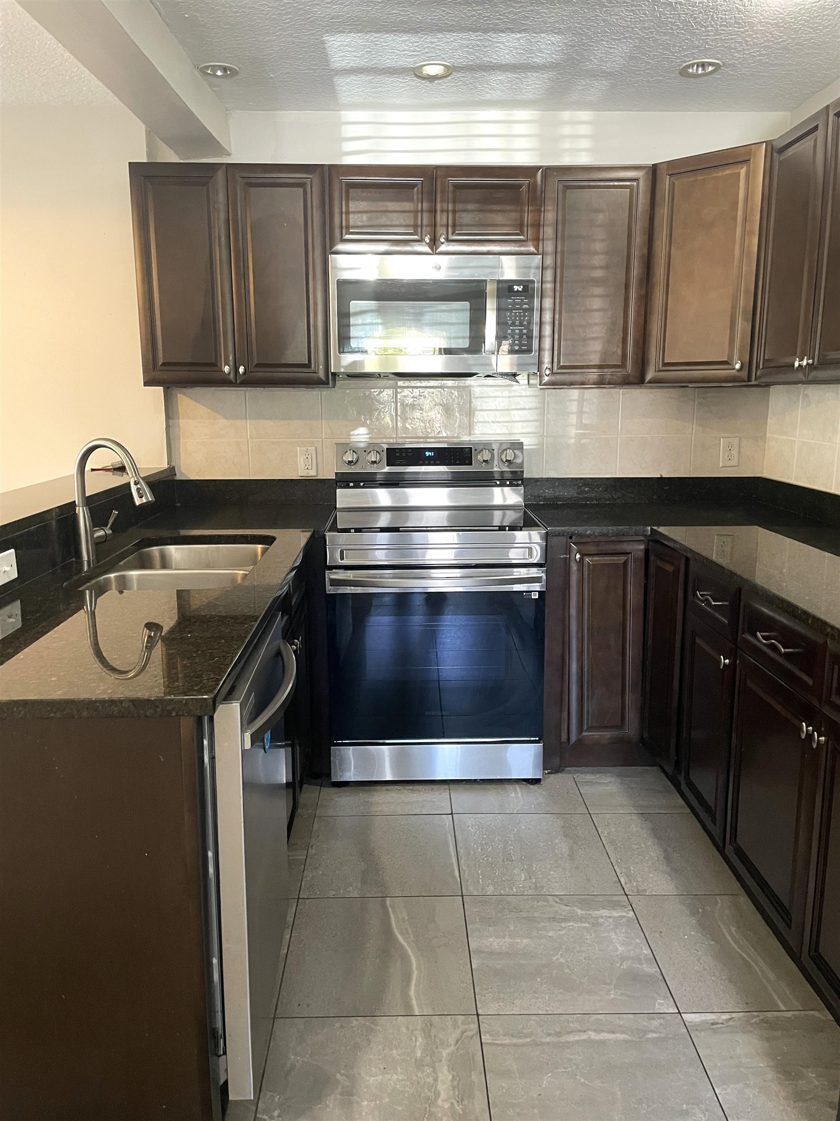 101 Flagler Boulevard, Unit A St. Augustine, FL 32080 - Photo 5 of 19 a kitchen with a stove a sink and a microwave