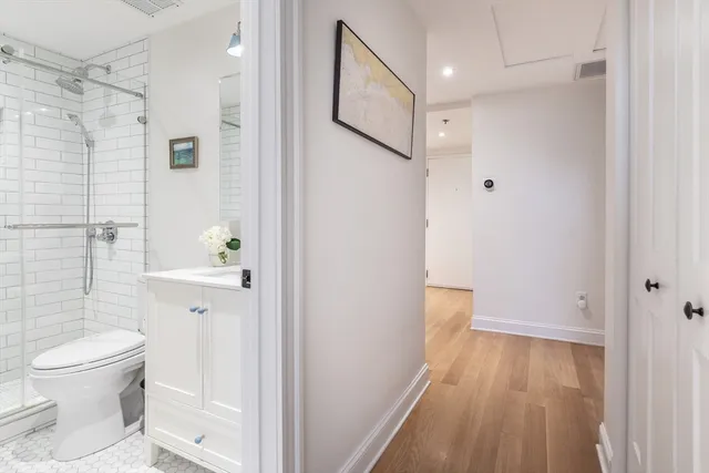 a bathroom with a toilet and a shower