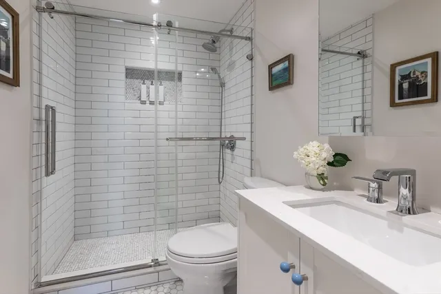 a bathroom with a sink toilet and shower