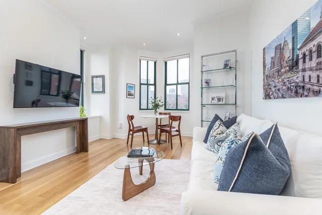 a living room with furniture and a kitchen