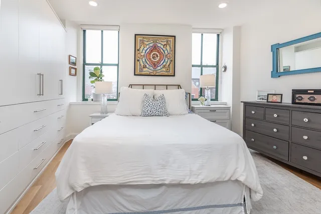 a spacious bedroom with a bed and a window