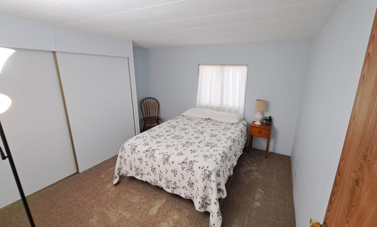 5766 Pony Express Trail, Unit 4 Pollock Pines, CA 95726 - Photo 12 of 17 a bedroom with a bed and a window