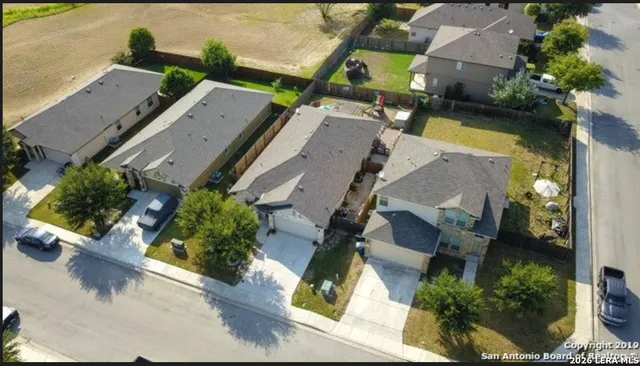 an aerial view of residential houses with outdoor space