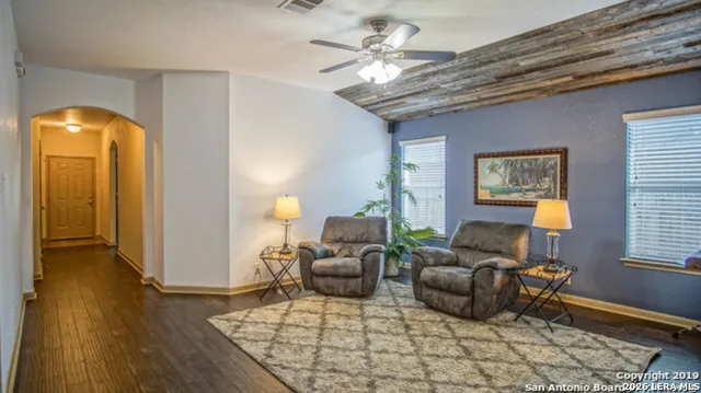 a living room with furniture and wooden floor