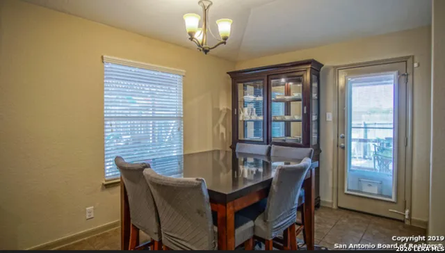a dining room with furniture and window