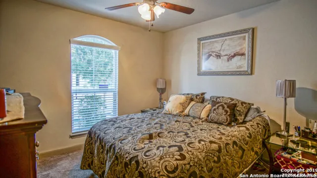 a bed sitting in a bedroom next to a window