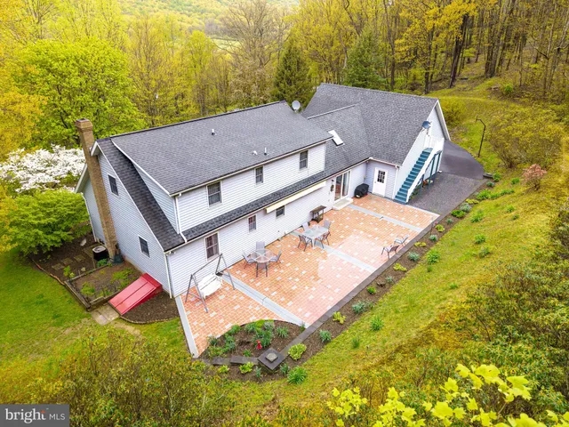 an aerial view of residential house with pool and yard