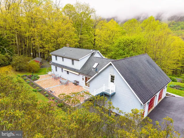 a aerial view of a house with a yard and lake view