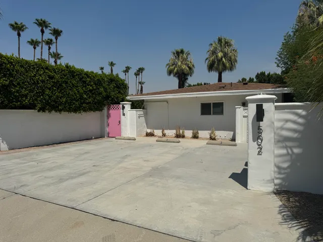 a view of a kitchen with a sink and wooden floor