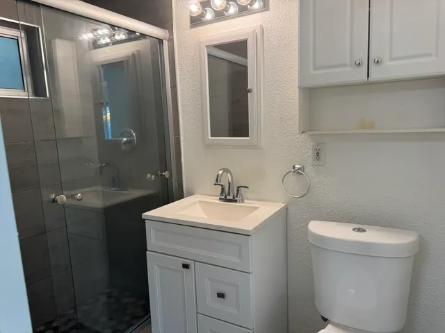 a view of bathroom with a toilet sink and a mirror