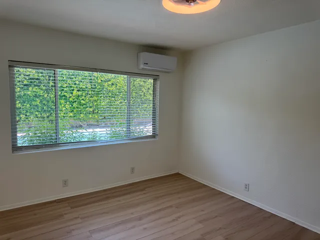 a bedroom with a large bed and a large window