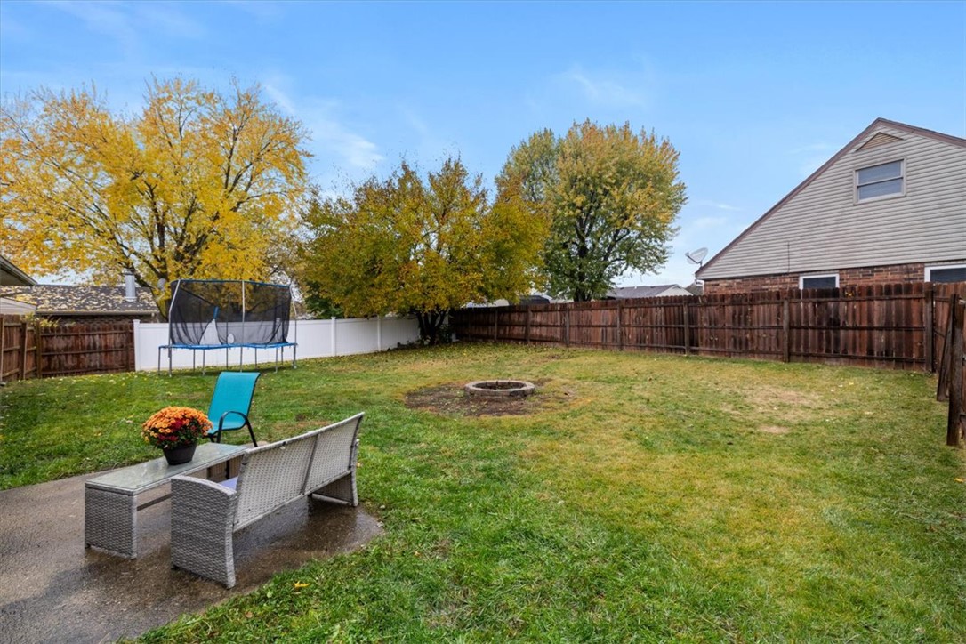 1482 Lee Road Troy, OH 45373 - Photo 24 of 30 This spacious yard features a fire pit and a privacy fence, perfect for outdoor enjoyment.