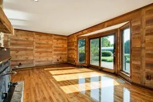 wooden floor in an empty room with a window