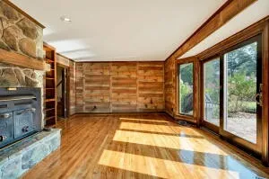 a view of a room with wooden floor and a window