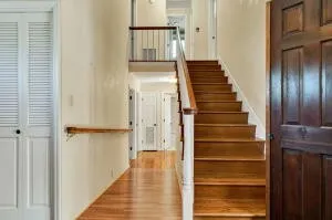 a front view of a house with a yard and trees