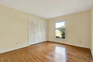 a front view of a house with a yard and potted plants