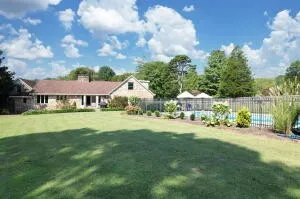 a view of outdoor space with a garden and trees