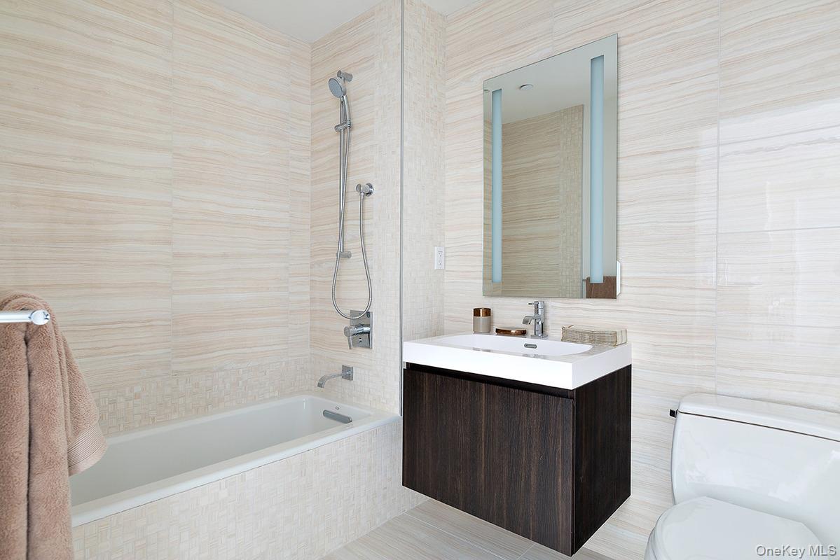 131-03 40 Road, Unit PH2G Queens, NY 11354 - Photo 14 of 29 a bathroom with a sink a toilet and shower