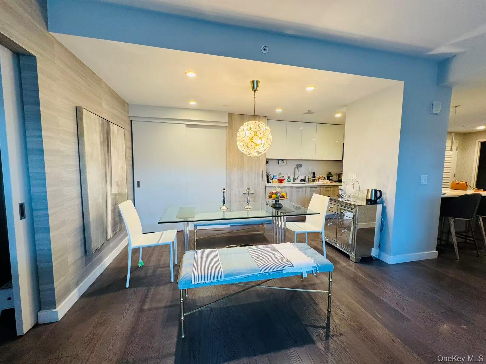131-03 40 Road, Unit PH2G Queens, NY 11354 - Photo 5 of 29 a room with wooden floor and furniture