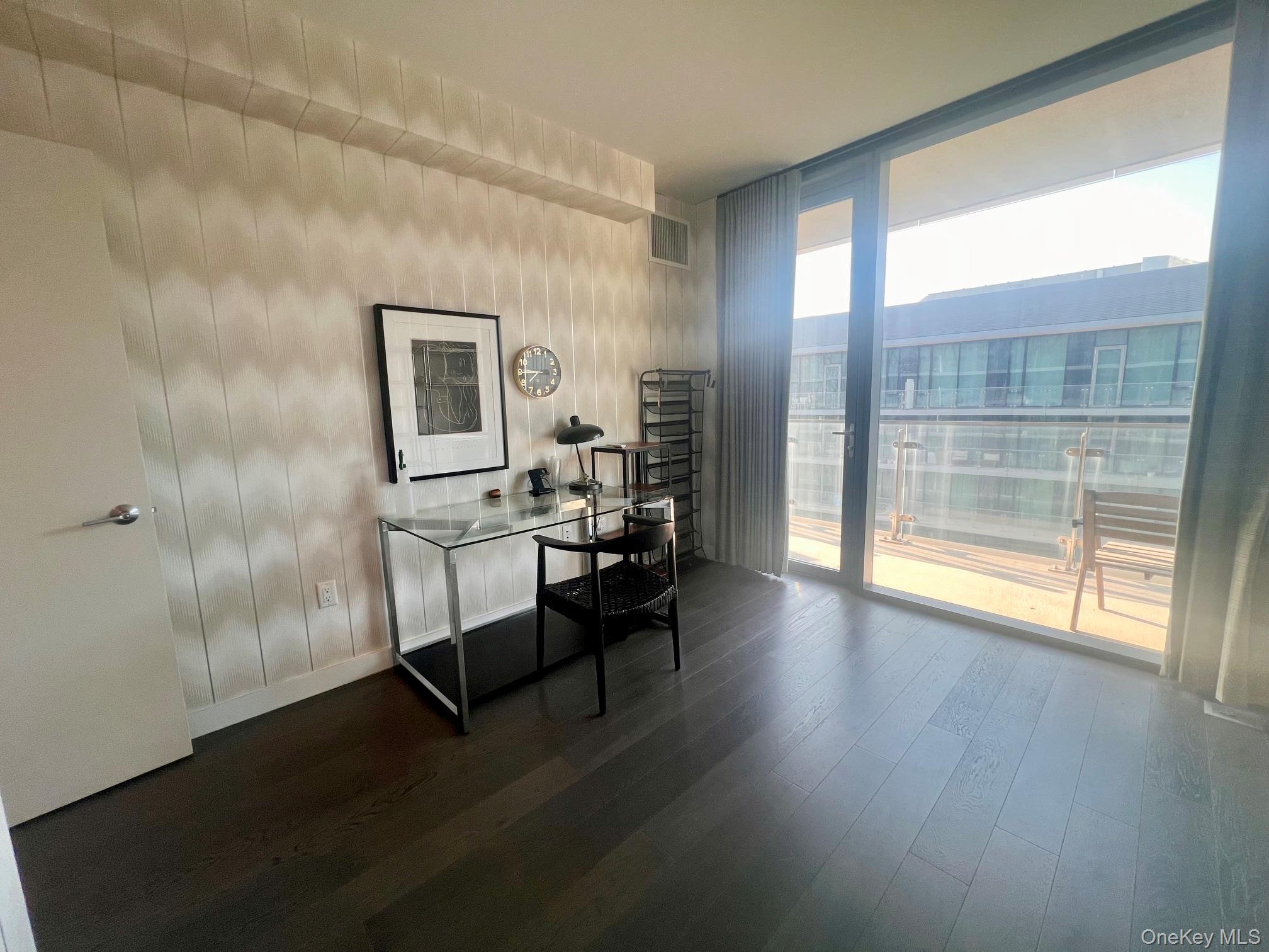 131-03 40 Road, Unit PH2G Queens, NY 11354 - Photo 7 of 29 a room with wooden floor and windows