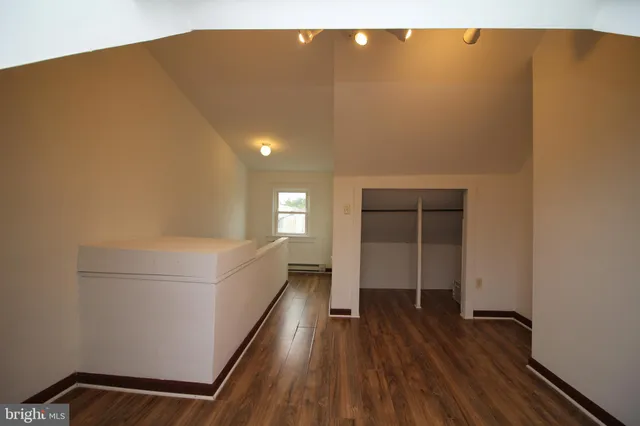 a view of hallway with wooden floor