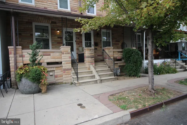 a view of a house with sitting area and potted plants