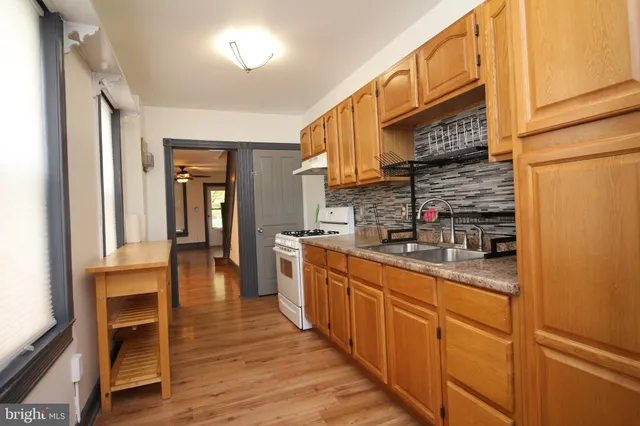 a kitchen with stainless steel appliances granite countertop a sink and cabinets