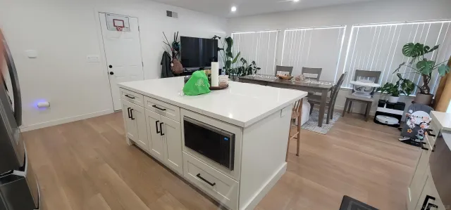 a kitchen with a stove a refrigerator and a dining table