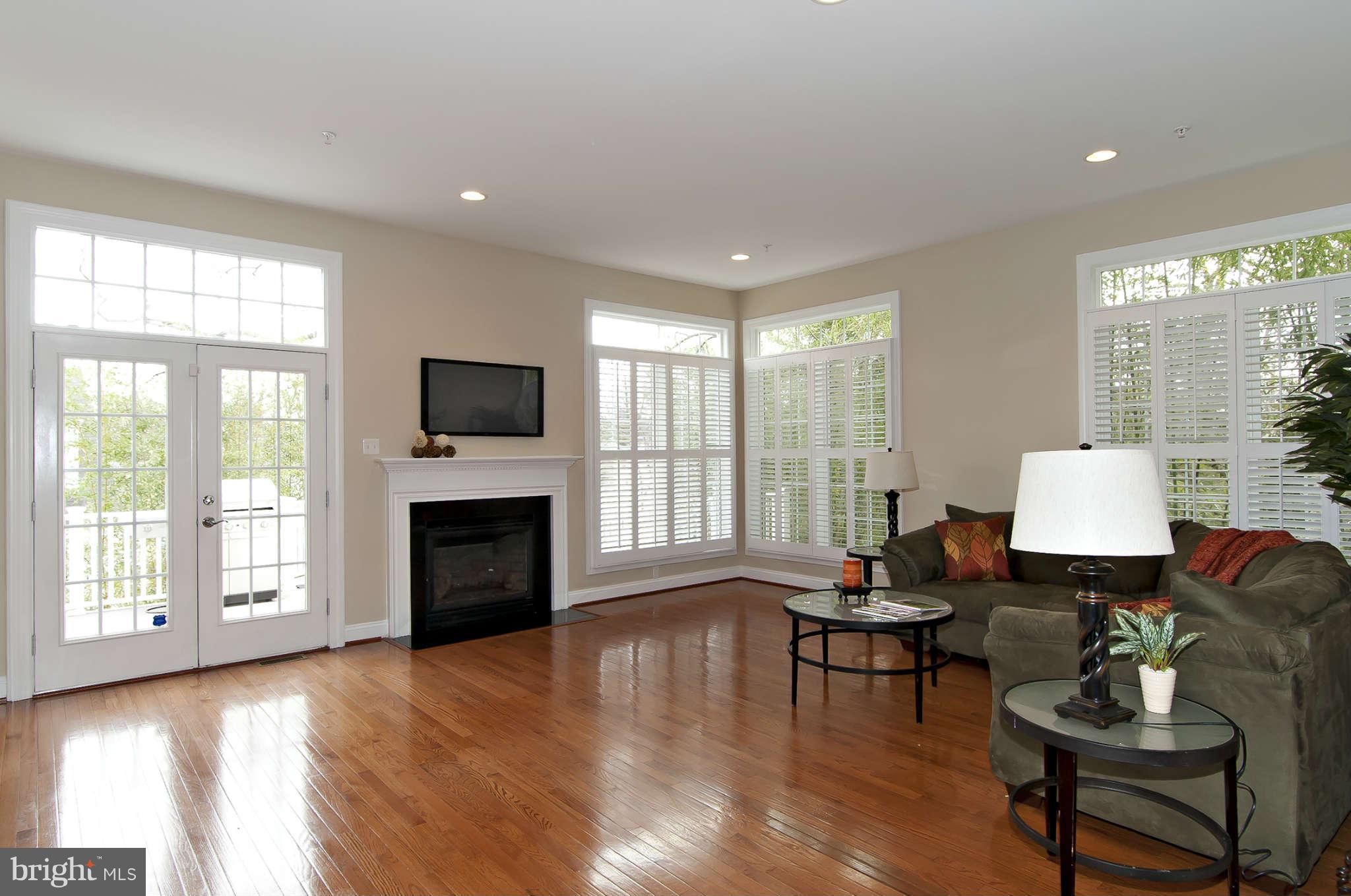 8407 Old Georgetown Road Bethesda, MD 20814 - Photo 12 of 30 a living room with furniture a fireplace and a large window