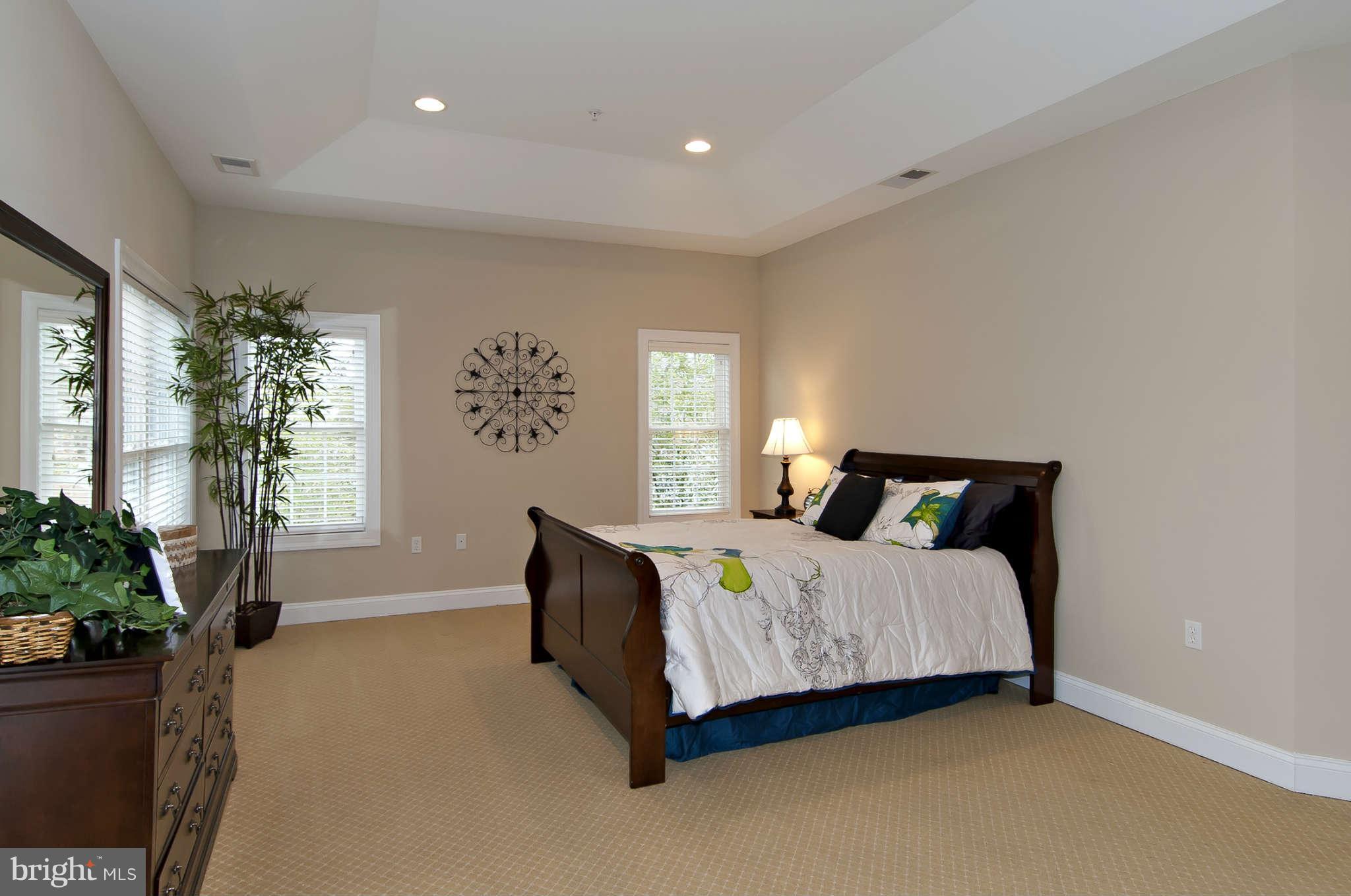 8407 Old Georgetown Road Bethesda, MD 20814 - Photo 13 of 30 a bedroom with a bed table and a window