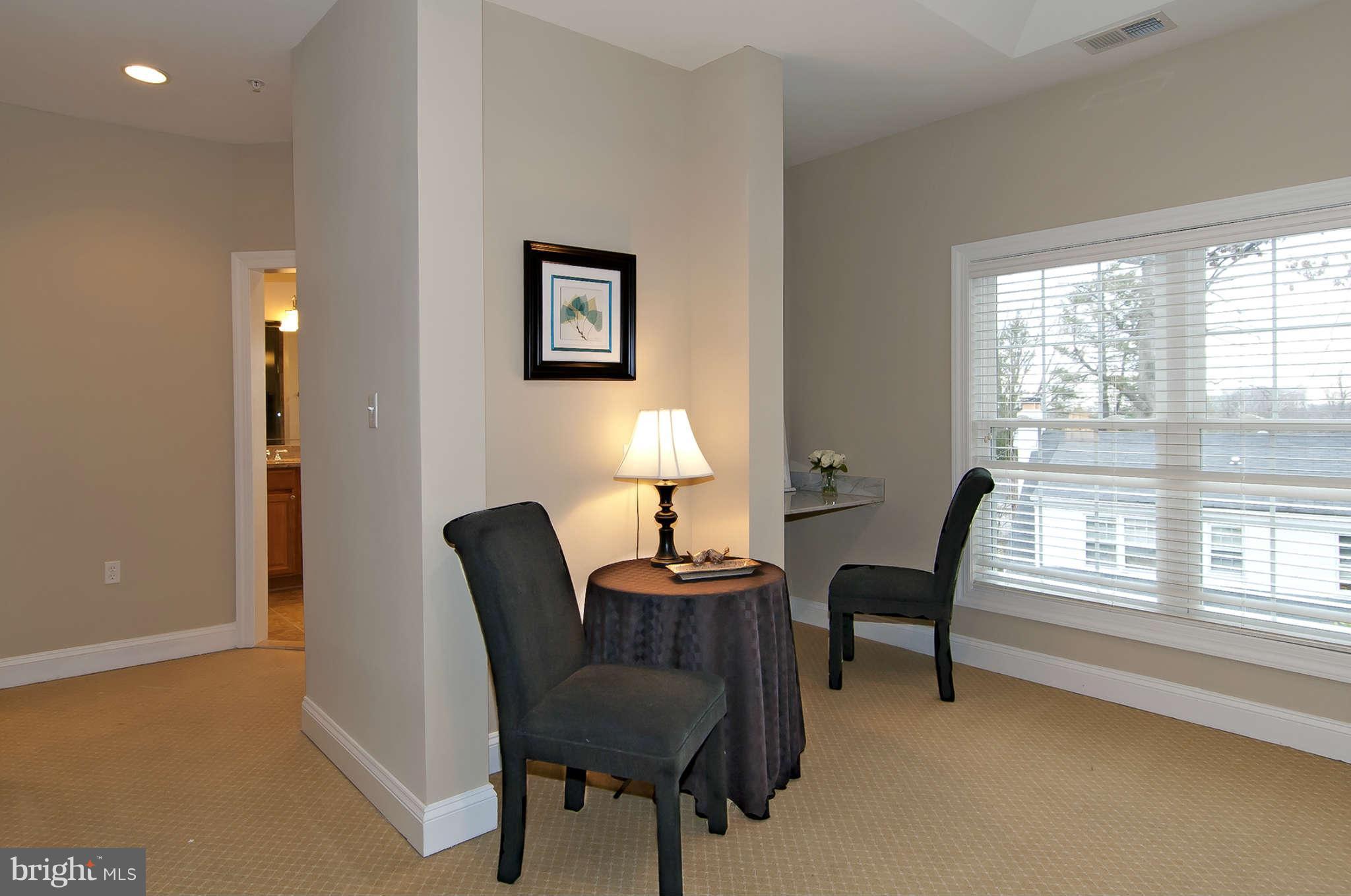 8407 Old Georgetown Road Bethesda, MD 20814 - Photo 15 of 30 a view of a workspace with furniture and a window