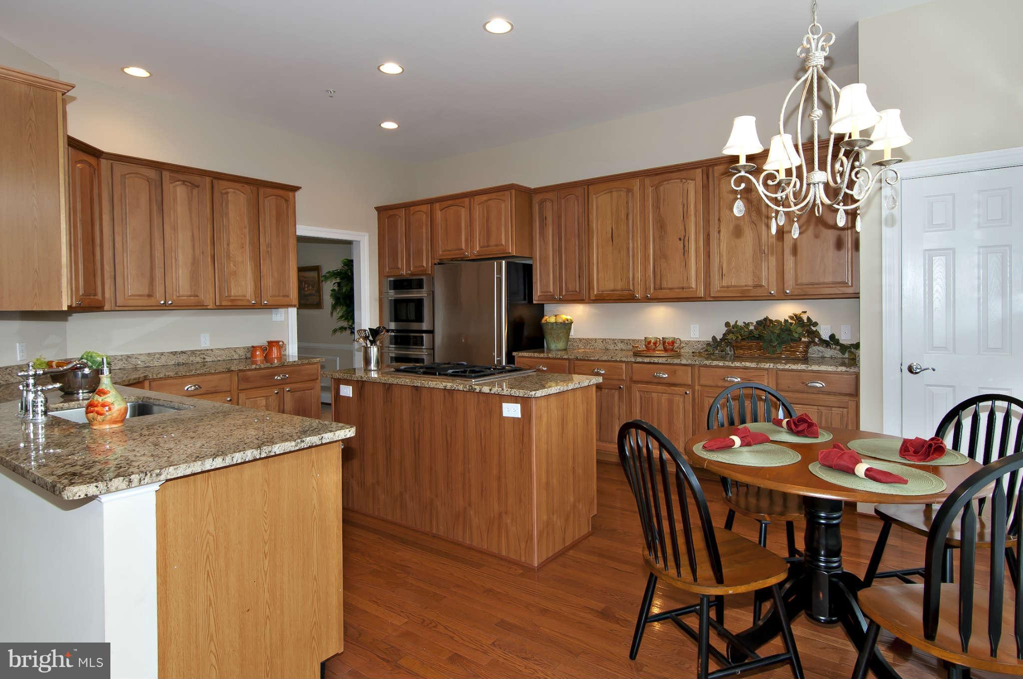 8407 Old Georgetown Road Bethesda, MD 20814 - Photo 7 of 30 a kitchen with a dining table chairs and refrigerator