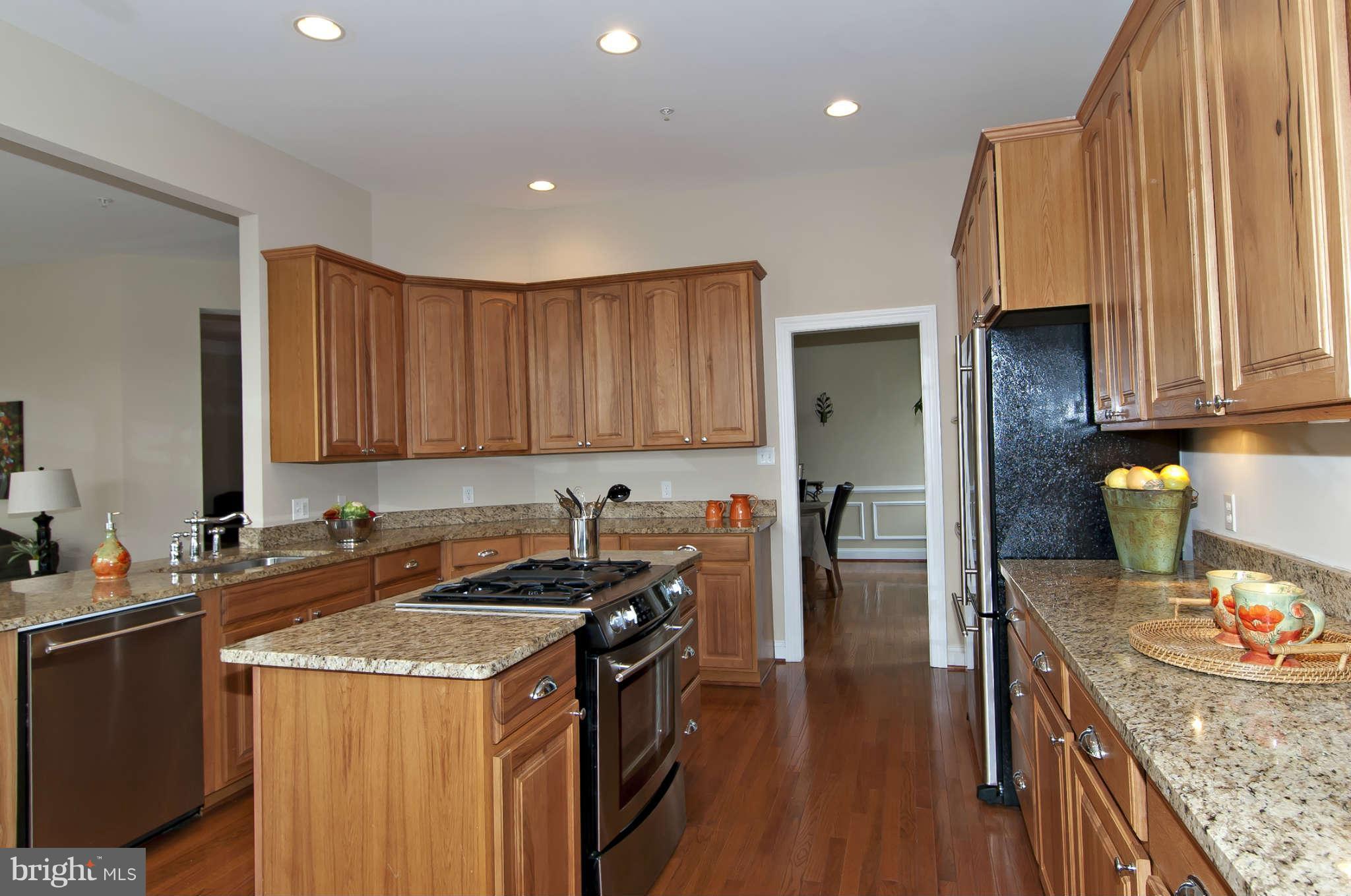 8407 Old Georgetown Road Bethesda, MD 20814 - Photo 8 of 30 a kitchen with a sink stove and cabinets