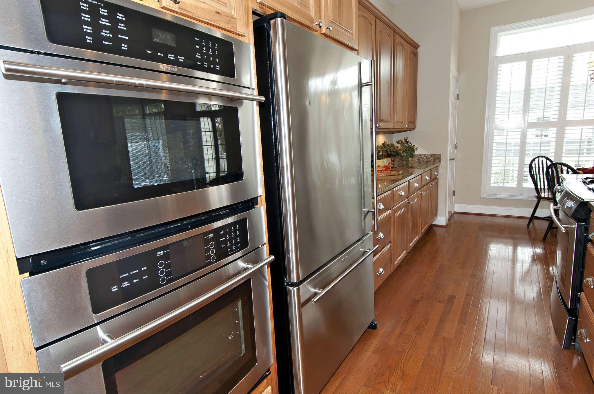 8407 Old Georgetown Road Bethesda, MD 20814 - Photo 10 of 30 a kitchen with granite countertop a stove and a refrigerator