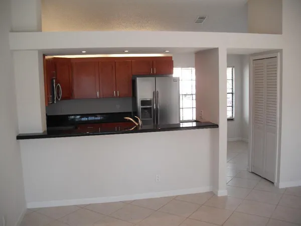 a kitchen with a refrigerator and a sink