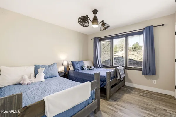 a bedroom with furniture and a wooden floor