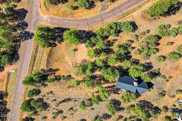 an aerial view of a houses with a yard