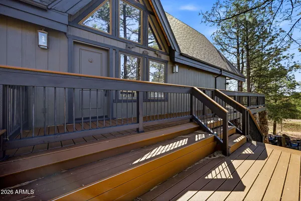 a view of balcony with wooden floor and fence